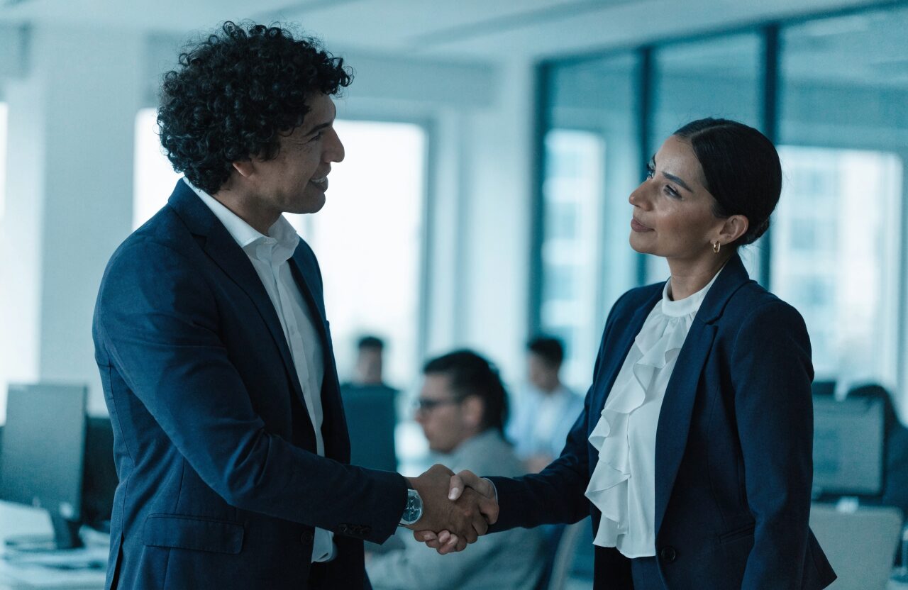 Dos profesionales estrechando la mano en señal de una alianza estratégica
